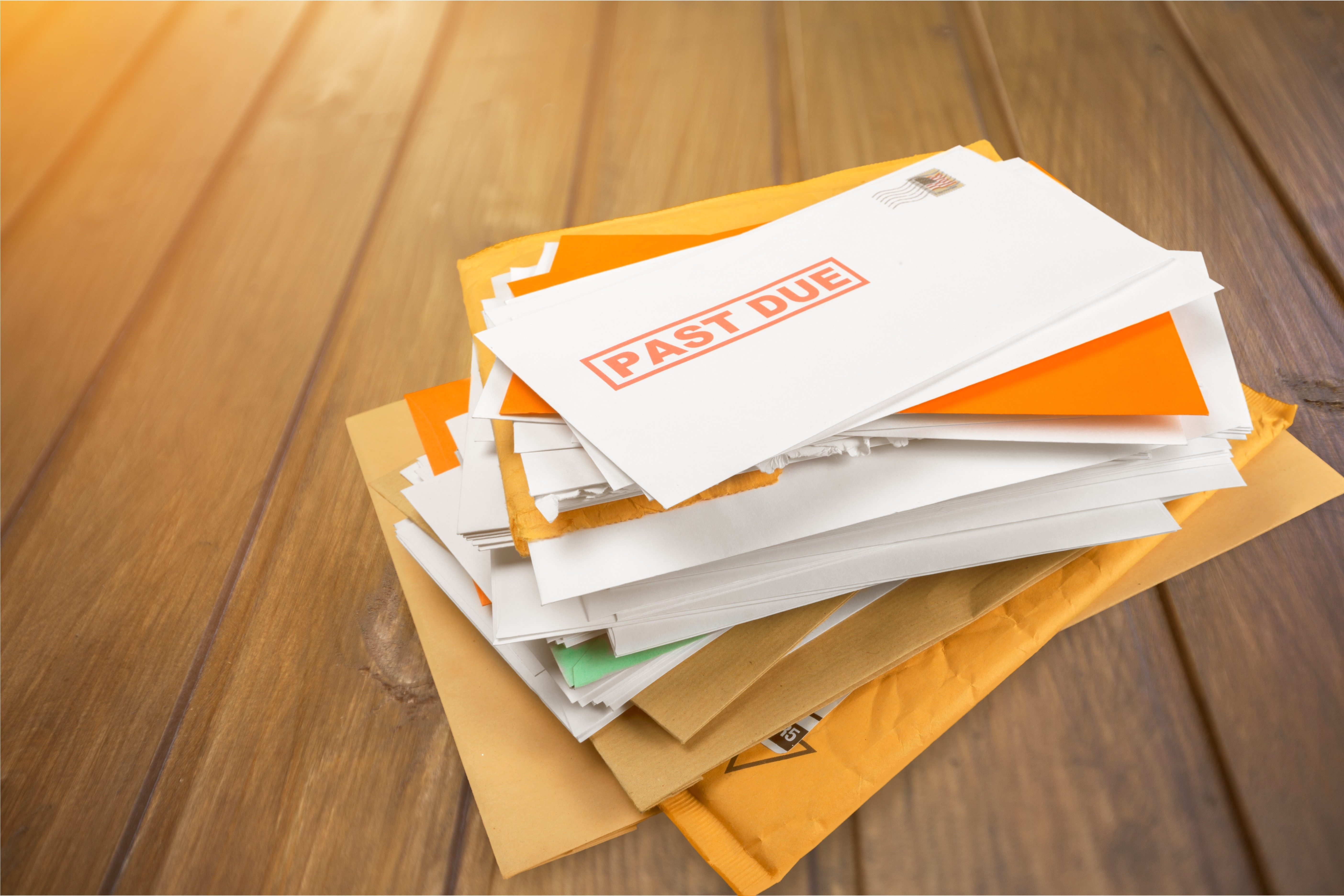 Pile of envelopes with overdue utility bills isolated on white